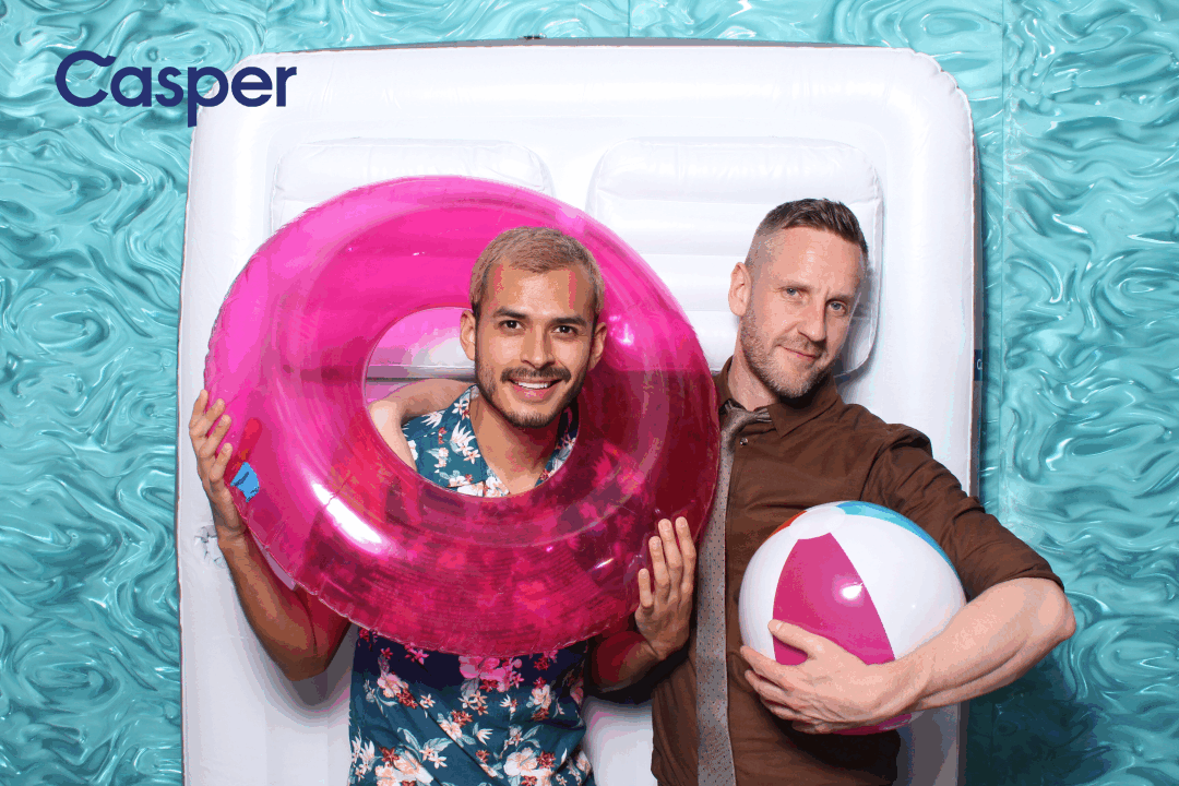 Two men posing in an animated GIF with a pool float and beach ball at Casper's Summer Party